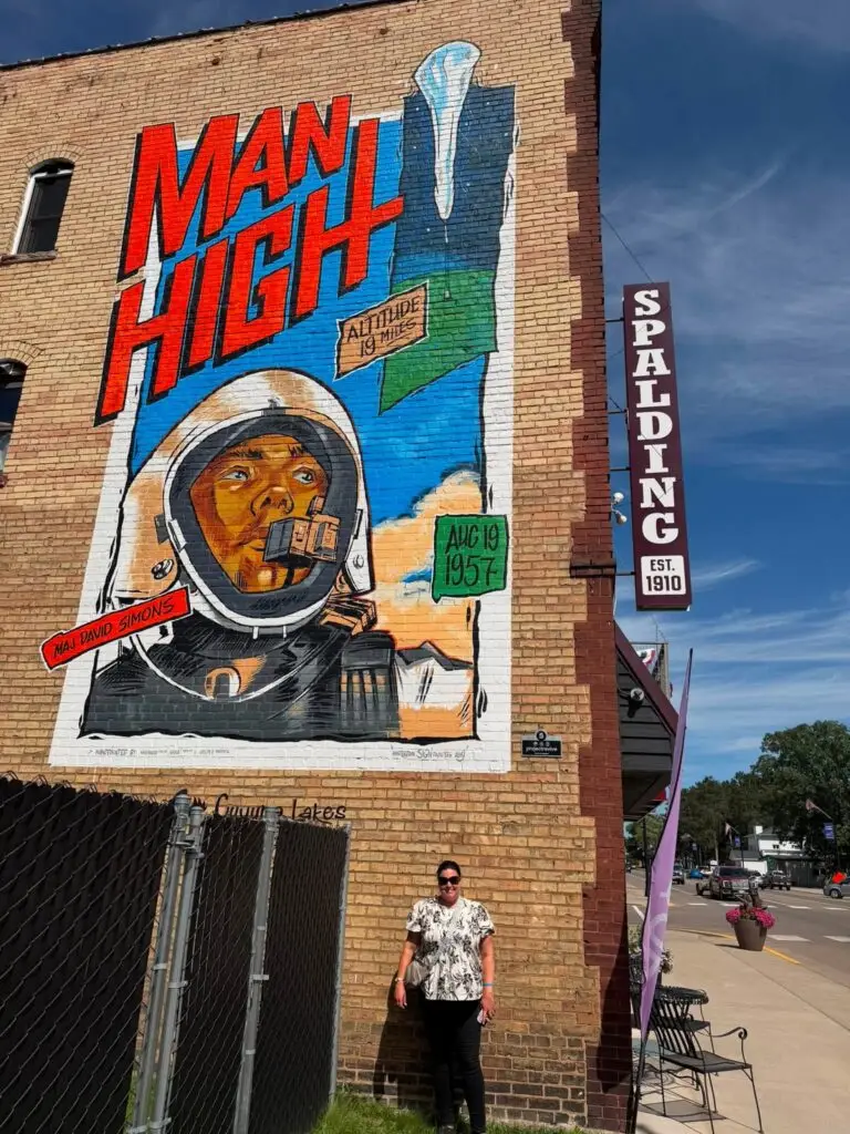 Trina with a moon high painted sign on a building.