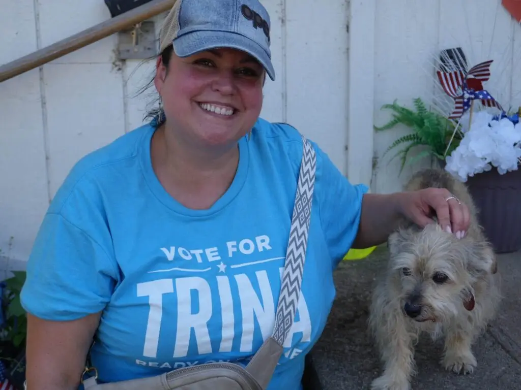 Trina with a cute dog on a bench.