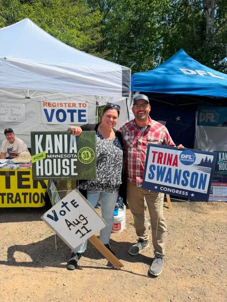 outdoor event where trina swanson supporters are holding signs.