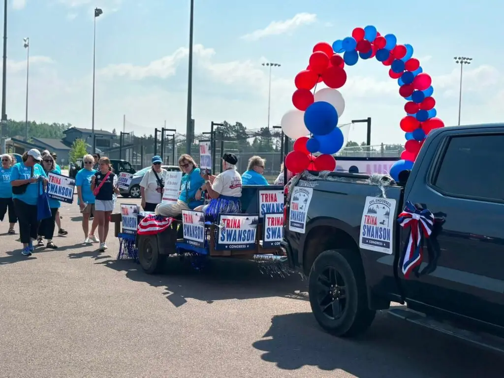 Aline of cars with Trina Swanson for congress signs.